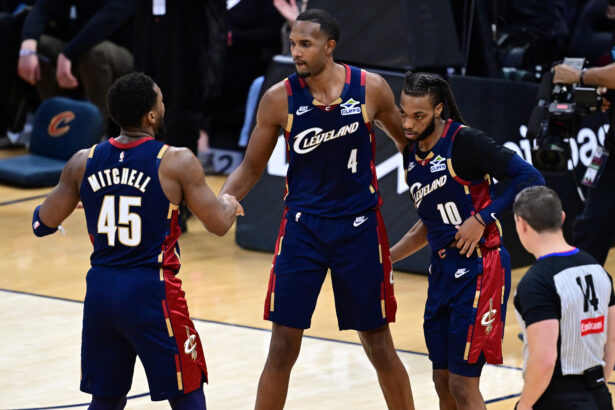 Jan 2, 2026; Cleveland, Ohio, USA; Cleveland Cavaliers center Evan Mobley (4) congratulates guard Donovan Mitchell (45) and guard Darius Garland (10) after the Cavaliers defeated the Denver Nuggets at Rocket Arena. Mandatory Credit: David Dermer-Imagn Images
