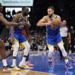 Dec 31, 2025; Charlotte, North Carolina, USA; Golden State Warriors guard Stephen Curry (30) takes the pass from forward Draymond Green (23) against the Charlotte Hornets during the second half at Spectrum Center. Mandatory Credit: Jim Dedmon-Imagn Images