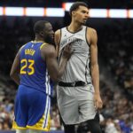 Nov 14, 2025; San Antonio, Texas, USA; San Antonio Spurs forward Victor Wembanyama (1) waits for an inbound pass while defended by Golden State Warriors forward Draymond Green (23) during the second half at Frost Bank Center. Mandatory Credit: Scott Wachter-Imagn Images