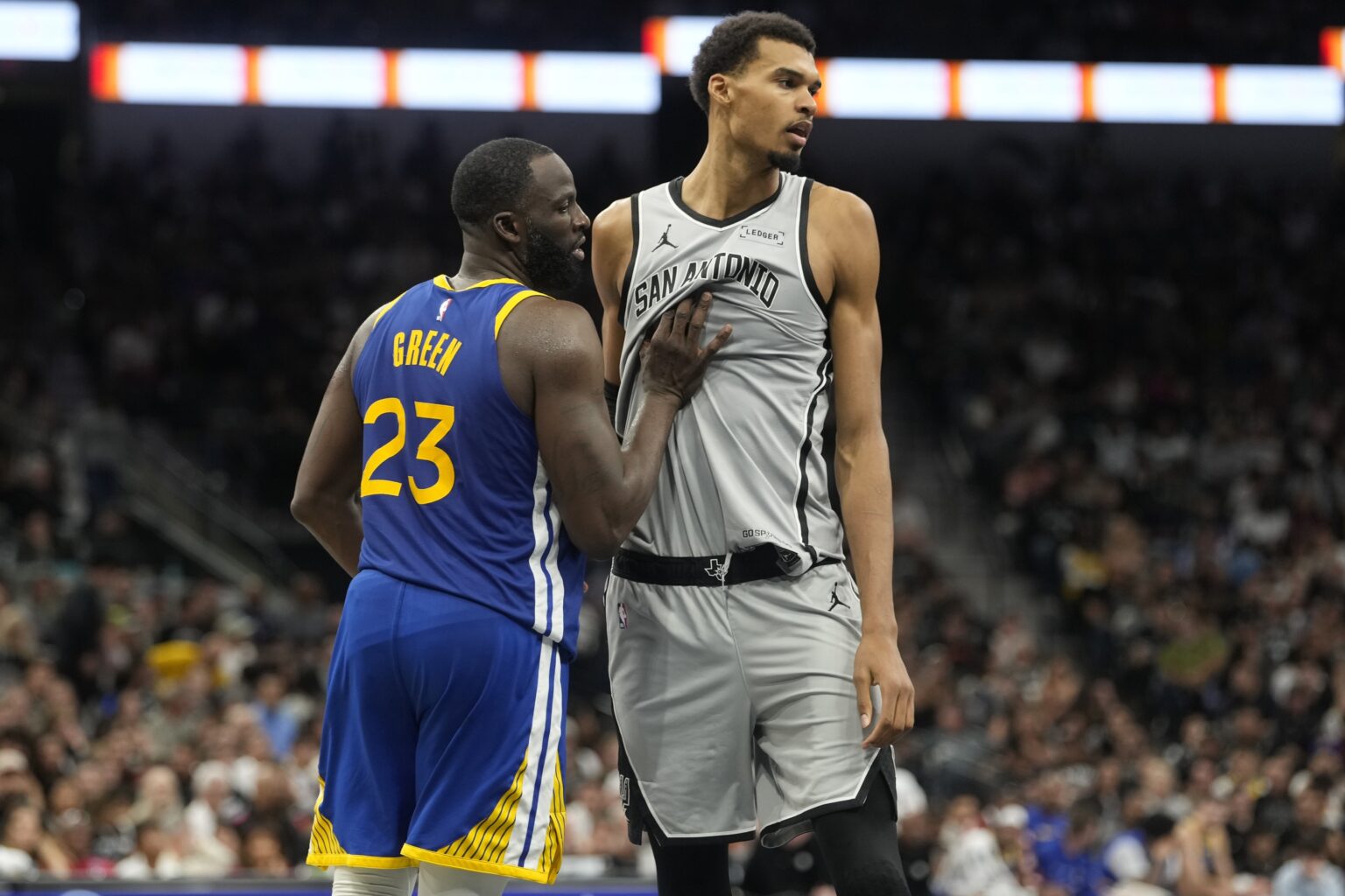 Nov 14, 2025; San Antonio, Texas, USA; San Antonio Spurs forward Victor Wembanyama (1) waits for an inbound pass while defended by Golden State Warriors forward Draymond Green (23) during the second half at Frost Bank Center. Mandatory Credit: Scott Wachter-Imagn Images