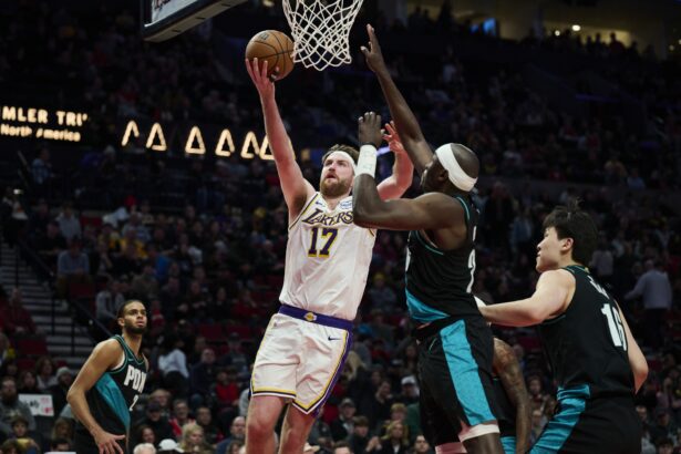 Jan 17, 2026; Portland, Oregon, USA; Los Angeles Lakers forward Drew Timme (17) drives to the basket during the second half against Portland Trail Blazers center Duop Reath (26) at Moda Center. Mandatory Credit: Troy Wayrynen-Imagn Images