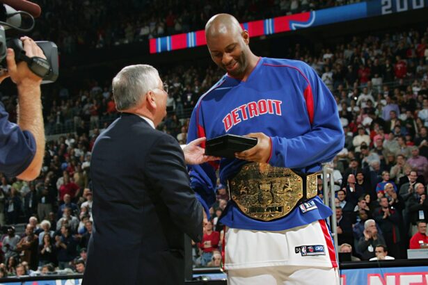 NOVEMBER 2: Elden Campbell #41 of the Detroit Pistons gets congratulated by NBA Commissioner David Stern during the championship ring ceremony prior to facing the Houston Rockets on November 2, 2004 at the Palace at Auburn Hills in Detroit, Michigan. Photo by Jesse D. Garrabrant/NBAE via Getty Images