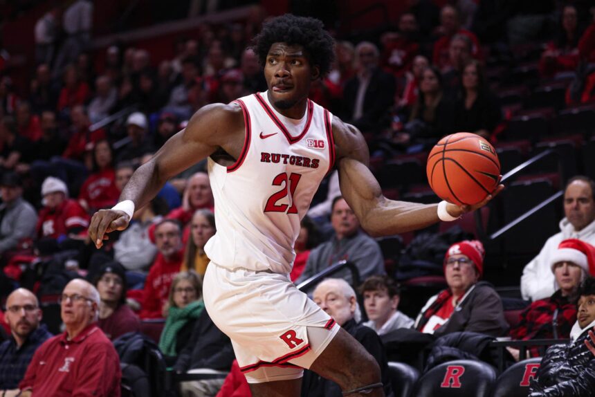 Rutgers Scarlet Knights center Emmanuel Ogbole (21) looks to pass the ball during the first half against the Penn Quakers at Jersey Mike's Arena.