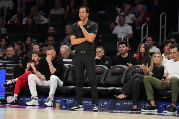 Jan 4, 2026; Miami, Florida, USA; Miami Heat head coach Erik Spoelstra keeps his eyes on his team during the first half at Kaseya Center against the New Orleans Pelicans. Mandatory Credit: Jim Rassol-Imagn Images