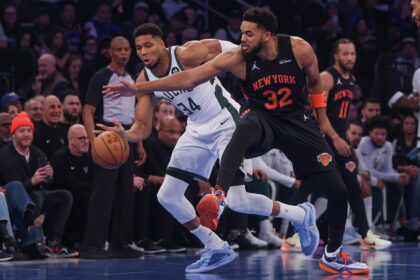 Nov 28, 2025; New York, New York, USA; Milwaukee Bucks forward Giannis Antetokounmpo (34) and New York Knicks center Karl-Anthony Towns (32) battle for the ball during the first half at Madison Square Garden. Mandatory Credit: Vincent Carchietta-Imagn Images