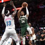 Apr 5, 2025; Miami, Florida, USA; Milwaukee Bucks forward Giannis Antetokounmpo (34) looks to pass the ball as Miami Heat center Bam Adebayo (13) defends during overtime at Kaseya Center. Mandatory Credit: Jim Rassol-Imagn Images