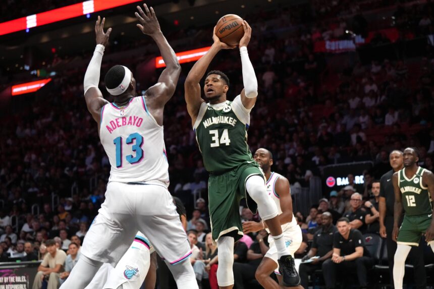 Apr 5, 2025; Miami, Florida, USA; Milwaukee Bucks forward Giannis Antetokounmpo (34) looks to pass the ball as Miami Heat center Bam Adebayo (13) defends during overtime at Kaseya Center. Mandatory Credit: Jim Rassol-Imagn Images