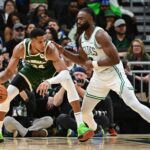 Milwaukee Bucks forward Giannis Antetokounmpo (34) is guarded by Boston Celtics forward Jaylen Brown (7) in the fourth quarter at Fiserv Forum.