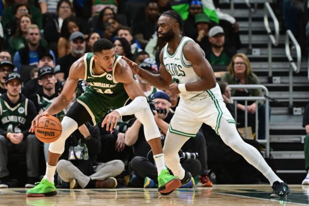 Milwaukee Bucks forward Giannis Antetokounmpo (34) is guarded by Boston Celtics forward Jaylen Brown (7) in the fourth quarter at Fiserv Forum.