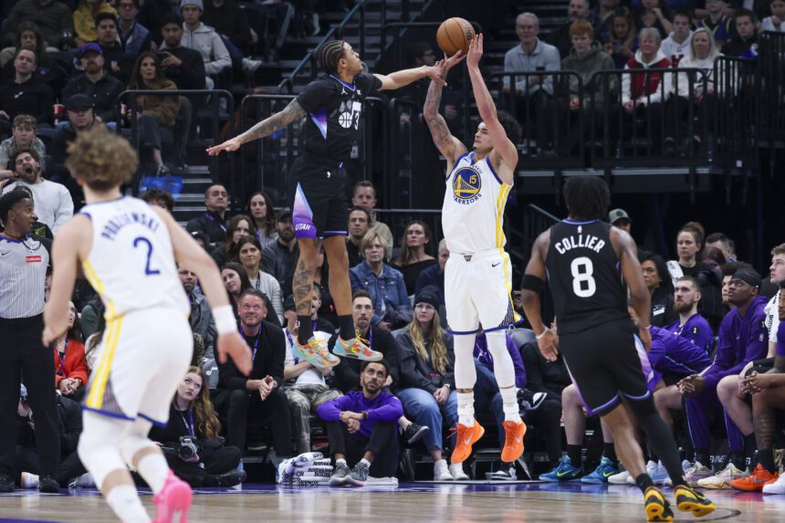 Jan 28, 2026; Salt Lake City, Utah, USA; Golden State Warriors forward Gui Santos (15) goes up for a shot against Utah Jazz guard Keyonte George (3) during the first half at Delta Center. Mandatory Credit: Rob Gray-Imagn Images