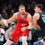 Nov 16, 2025; Boston, Massachusetts, USA; Boston Celtics forward Luka Garza (52) defends Los Angeles Clippers center Ivica Zubac (40) during the first half at TD Garden. Mandatory Credit: Paul Rutherford-Imagn Images