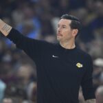 Jan 28, 2026; Cleveland, Ohio, USA; Los Angeles Lakers head coach JJ Redick calls a play in the first quarter against the Cleveland Cavaliers at Rocket Arena. Mandatory Credit: David Richard-Imagn Images