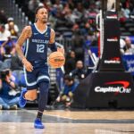 Dec 28, 2025; Washington, District of Columbia, USA; Memphis Grizzlies guard Ja Morant (12) advances the ball against the Washington Wizards during the first half at Capital One Arena. Mandatory Credit: Brad Mills-Imagn Images