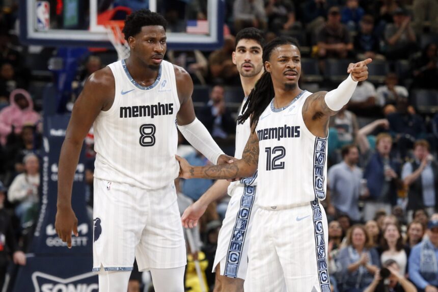 Dec 26, 2025; Memphis, Tennessee, USA; Memphis Grizzlies guard Ja Morant (12) reacts with forward/center Jaren Jackson Jr. (8) during the fourth quarter against the Milwaukee Bucks at FedExForum. Mandatory Credit: Petre Thomas-Imagn Images