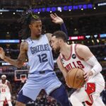 Memphis Grizzlies guard Ja Morant (12) defends against Chicago Bulls guard Zach LaVine (8) during the second half at United Center.