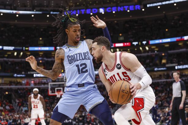 Memphis Grizzlies guard Ja Morant (12) defends against Chicago Bulls guard Zach LaVine (8) during the second half at United Center.