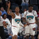 Feb 28, 2025; Memphis, Tennessee, USA; Memphis Grizzlies guard Ja Morant (12) reacts with guard Vince Williams Jr. (5) during the first quarter against the New York Knicks at FedExForum. Mandatory Credit: Petre Thomas-Imagn Images