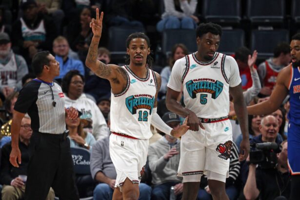 Feb 28, 2025; Memphis, Tennessee, USA; Memphis Grizzlies guard Ja Morant (12) reacts with guard Vince Williams Jr. (5) during the first quarter against the New York Knicks at FedExForum. Mandatory Credit: Petre Thomas-Imagn Images