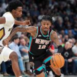 Grizzlies' Ja Morant (12) drives to the basket during the home opener against the New Orleans Pelicans at FedExForum on October 22, 2025.