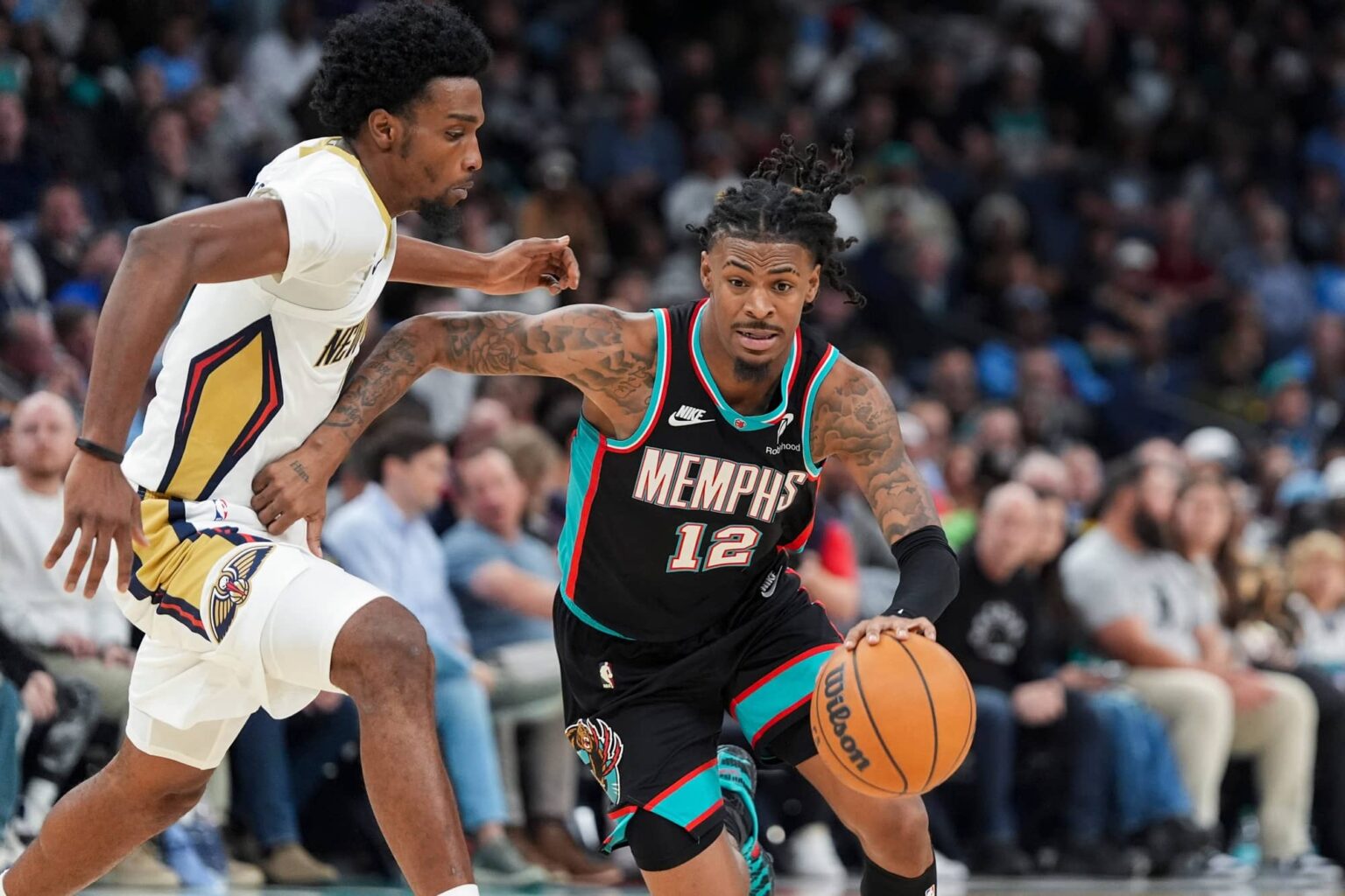 Grizzlies' Ja Morant (12) drives to the basket during the home opener against the New Orleans Pelicans at FedExForum on October 22, 2025.