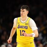 Dec 23, 2025; Phoenix, Arizona, USA; Los Angeles Lakers forward Jake LaRavia (12) against the Phoenix Suns at Mortgage Matchup Center. Mandatory Credit: Mark J. Rebilas-Imagn Images