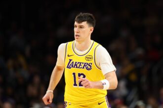 Dec 23, 2025; Phoenix, Arizona, USA; Los Angeles Lakers forward Jake LaRavia (12) against the Phoenix Suns at Mortgage Matchup Center. Mandatory Credit: Mark J. Rebilas-Imagn Images