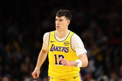 Dec 23, 2025; Phoenix, Arizona, USA; Los Angeles Lakers forward Jake LaRavia (12) against the Phoenix Suns at Mortgage Matchup Center. Mandatory Credit: Mark J. Rebilas-Imagn Images