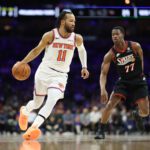 Jan 24, 2026; Philadelphia, Pennsylvania, USA; New York Knicks guard Jalen Brunson (11) dribbles the ball in front of Philadelphia 76ers guard Vj Edgecombe (77) during the first quarter at Xfinity Mobile Arena. Mandatory Credit: Bill Streicher-Imagn Images