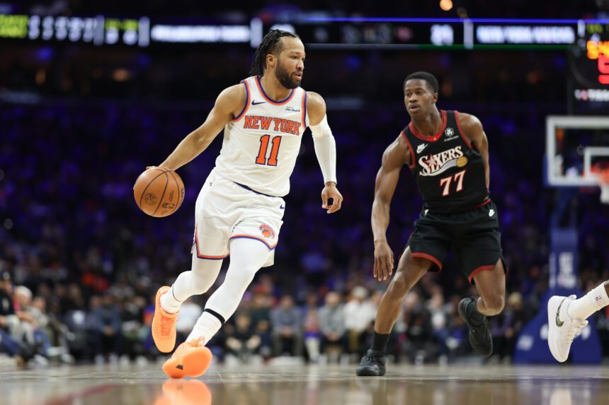 Jan 24, 2026; Philadelphia, Pennsylvania, USA; New York Knicks guard Jalen Brunson (11) dribbles the ball in front of Philadelphia 76ers guard Vj Edgecombe (77) during the first quarter at Xfinity Mobile Arena. Mandatory Credit: Bill Streicher-Imagn Images