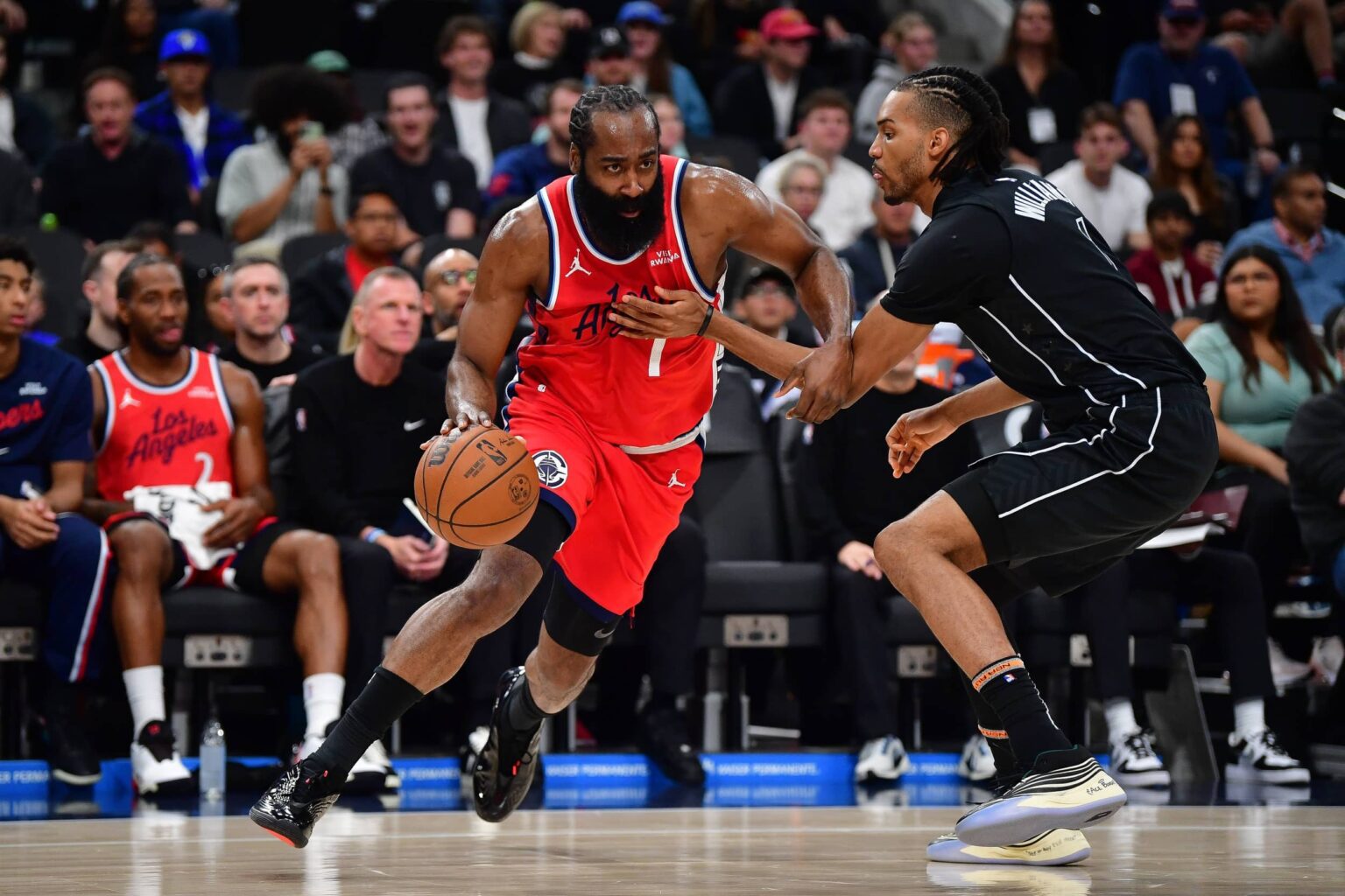 Jan 25, 2026; Inglewood, California, USA; Los Angeles Clippers guard James Harden (1) moves to the basket against Brooklyn Nets' Ziaire Williams (1) during the first half at Intuit Dome. Mandatory Credit: Gary A. Vasquez-Imagn Images