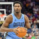 Dec 23, 2025; Salt Lake City, Utah, USA; Memphis Grizzlies forward/center Jaren Jackson Jr. (8) looks to pass around Utah Jazz center Kyle Filipowski (22) during the first half at Delta Center. Mandatory Credit: Peter Creveling-Imagn Images