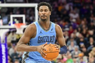 Dec 23, 2025; Salt Lake City, Utah, USA; Memphis Grizzlies forward/center Jaren Jackson Jr. (8) looks to pass around Utah Jazz center Kyle Filipowski (22) during the first half at Delta Center. Mandatory Credit: Peter Creveling-Imagn Images