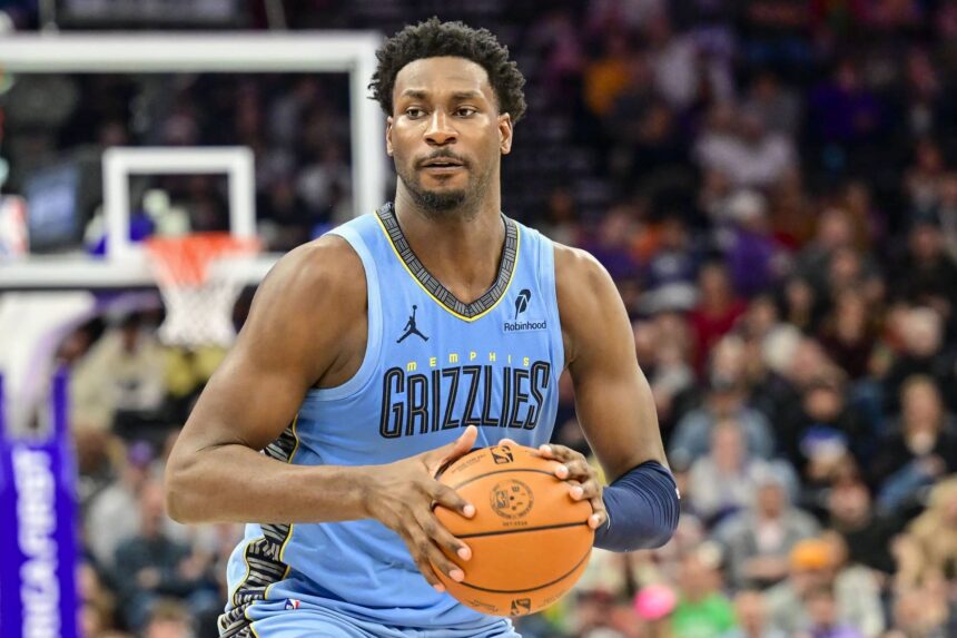 Dec 23, 2025; Salt Lake City, Utah, USA; Memphis Grizzlies forward/center Jaren Jackson Jr. (8) looks to pass around Utah Jazz center Kyle Filipowski (22) during the first half at Delta Center. Mandatory Credit: Peter Creveling-Imagn Images