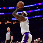 Dec 25, 2025; Los Angeles, California, USA; Los Angeles Lakers forward Jarred Vanderbilt (2) shoots three point basket against the Houston Rockets during the first half at Crypto.com Arena. Mandatory Credit: Gary A. Vasquez-Imagn Images