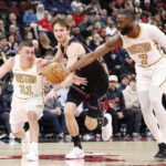 Jan 24, 2026; Chicago, Illinois, USA; Boston Celtics guard Payton Pritchard (11) and guard Jaylen Brown (7) defend against Chicago Bulls forward Matas Buzelis (14) during the first half at United Center. Mandatory Credit: Kamil Krzaczynski-Imagn Images