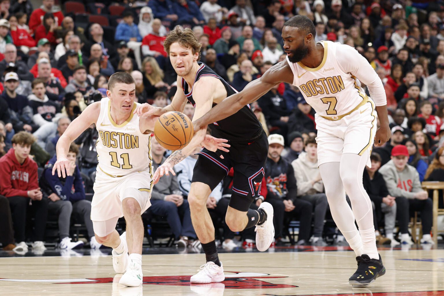 Jan 24, 2026; Chicago, Illinois, USA; Boston Celtics guard Payton Pritchard (11) and guard Jaylen Brown (7) defend against Chicago Bulls forward Matas Buzelis (14) during the first half at United Center. Mandatory Credit: Kamil Krzaczynski-Imagn Images