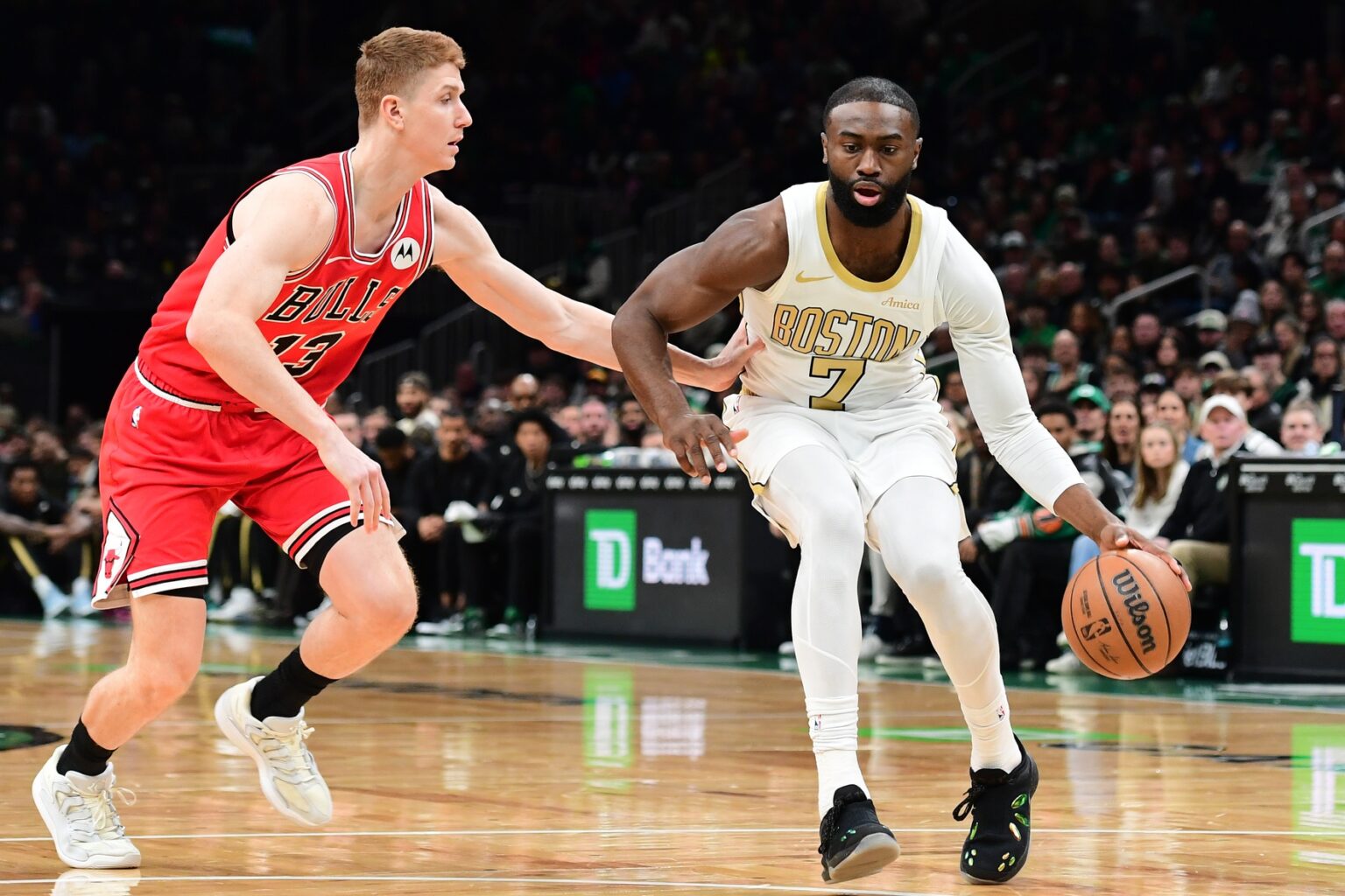 Jan 5, 2026; Boston, Massachusetts, USA; Boston Celtics guard Jaylen Brown (7) controls the ball while Chicago Bulls guard Kevin Huerter (13) defends during the first half at TD Garden. Mandatory Credit: Bob DeChiara-Imagn Images