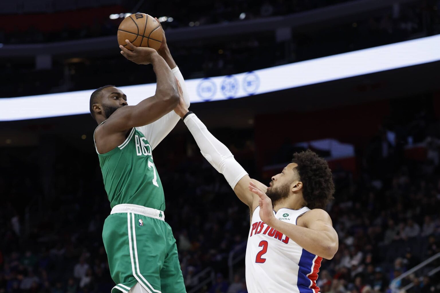 Jan 19, 2026; Detroit, Michigan, USA; Boston Celtics guard Jaylen Brown (7) shoots the ball against Detroit Pistons guard Cade Cunningham (2) in the first half at Little Caesars Arena. Mandatory Credit: Rick Osentoski-Imagn Images