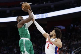 Jan 19, 2026; Detroit, Michigan, USA; Boston Celtics guard Jaylen Brown (7) shoots the ball against Detroit Pistons guard Cade Cunningham (2) in the first half at Little Caesars Arena. Mandatory Credit: Rick Osentoski-Imagn Images