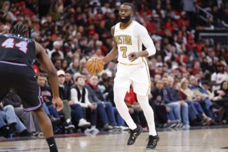Boston Celtics guard Jaylen Brown (7) brings the ball up court against the Chicago Bulls during the second half at United Center.
