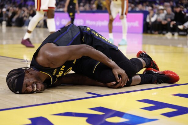 Jan 19, 2026; San Francisco, California, USA; Golden State Warriors forward Jimmy Butler III (10) holds his right knee as he goes down with an injury during the third quarter against the Miami Heat at Chase Center. Mandatory Credit: Kelley L Cox-Imagn Images