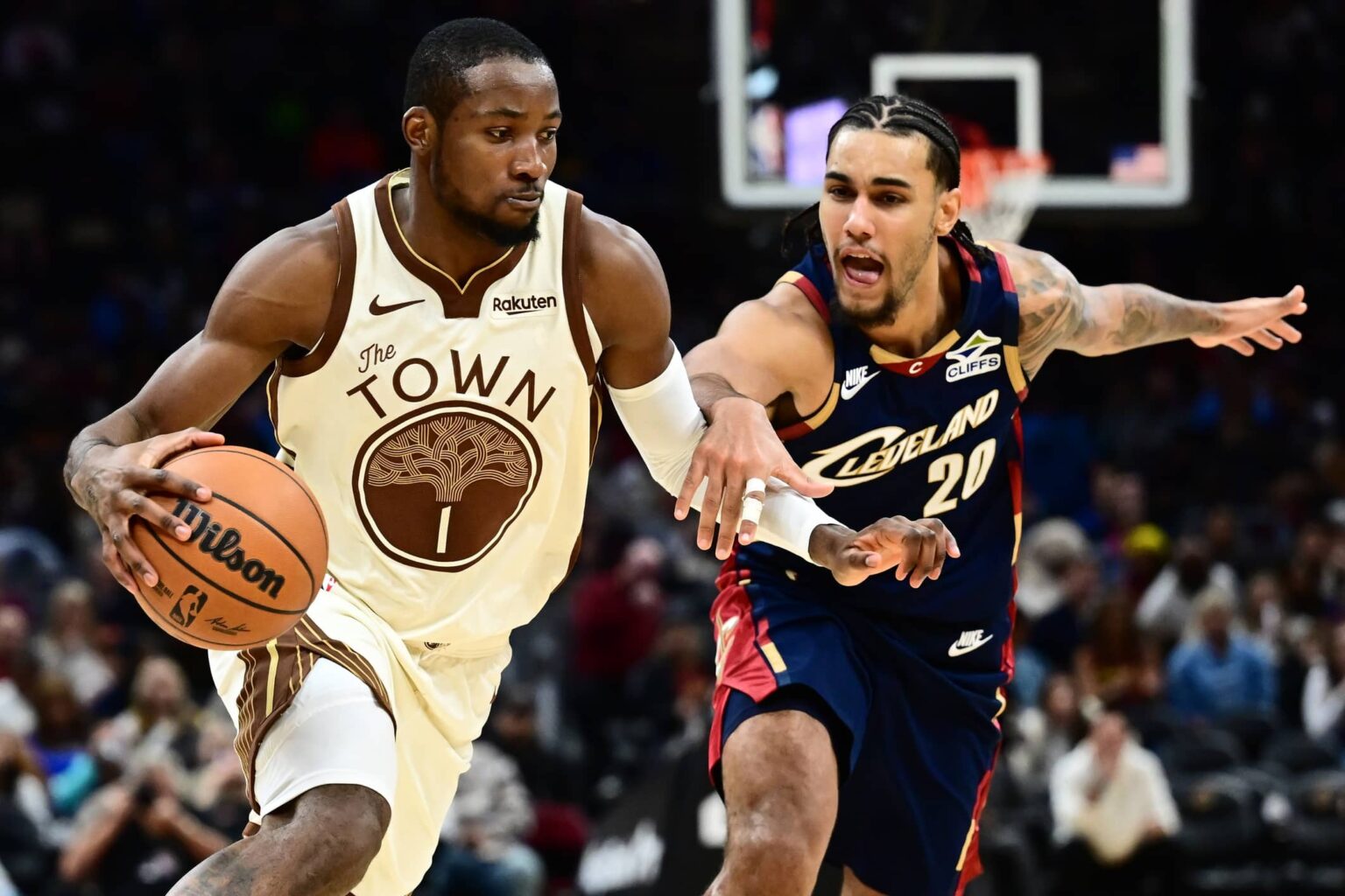 Golden State Warriors forward Jonathan Kuminga (1) drives to the basket against Cleveland Cavaliers guard Jaylon Tyson (20) during the second half at Rocket Arena.