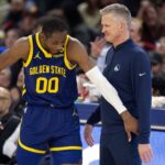 Jan 25, 2024; San Francisco, California, USA; Golden State Warriors forward Jonathan Kuminga (00) reacts after a foul with head coach Steve Kerr against the Sacramento Kings during the second quarter at Chase Center. Mandatory Credit: D. Ross Cameron-Imagn Images