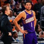Nov 23, 2025; Phoenix, Arizona, USA: Phoenix Suns Head Coach Jordan Ott and Phoenix Suns guard Devin Booker (1) talk in the first half of the game at Mortgage Match Up Center. Mandatory Credit: Arianna Grainey-Imagn Images