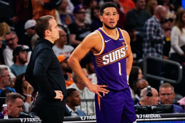 Nov 23, 2025; Phoenix, Arizona, USA: Phoenix Suns Head Coach Jordan Ott and Phoenix Suns guard Devin Booker (1) talk in the first half of the game at Mortgage Match Up Center. Mandatory Credit: Arianna Grainey-Imagn Images