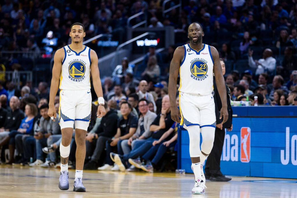 Golden State Warriors guard Jordan Poole (3) and forward Draymond Green (23) return to the court after a time-out taken by the Denver Nuggets during the first half at Chase Center. 