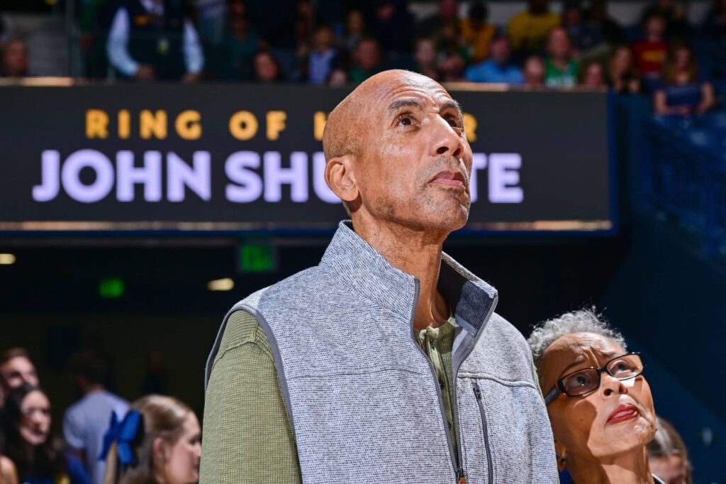 Dec 11, 2022; South Bend, Indiana, USA; Former Notre Dame player John Shumate watches watches a video tribute before he was inducted into the Notre Dame Ring of Honor during halftime of the game between the Notre Dame Fighting Irish and the Marquette Golden Eagles at the Purcell Pavilion. Mandatory Credit: Matt Cashore-Imagn Images