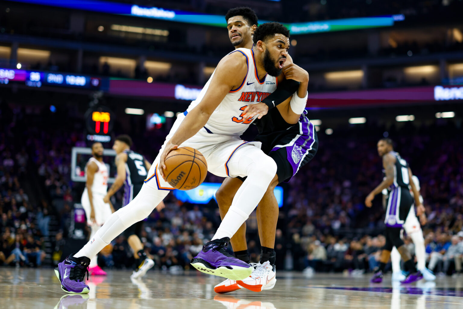 Jan 14, 2026; Sacramento, California, USA; New York Knicks center Karl-Anthony Towns (32) drives with the ball against Sacramento Kings center Dylan Cardwell (32) during the second quarter at Golden 1 Center. Mandatory Credit: Sergio Estrada-Imagn Images