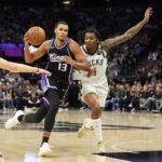 Mar 22, 2025; Sacramento, California, USA; Sacramento Kings forward Keegan Murray (13) drives against Milwaukee Bucks forward Bobby Portis (right) during the fourth quarter at Golden 1 Center. Mandatory Credit: Darren Yamashita-Imagn Images