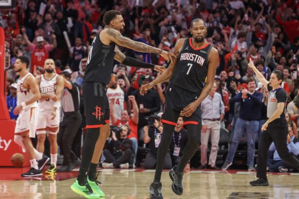 Jan 5, 2026; Houston, Texas, USA; Houston Rockets forward Jabari Smith Jr. (10) celebrates forward Kevin Durant (7) three point winning basket against the Phoenix Suns in the fourth quarter at Toyota Center. Mandatory Credit: Thomas Shea-Imagn Images